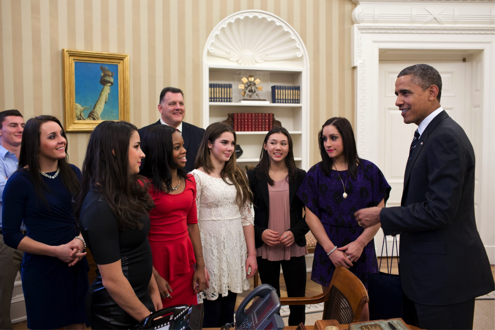 candid photo of Barack Obama, who is tall, and USA women's gymnasts, who are short, illustrates the concept of contrast