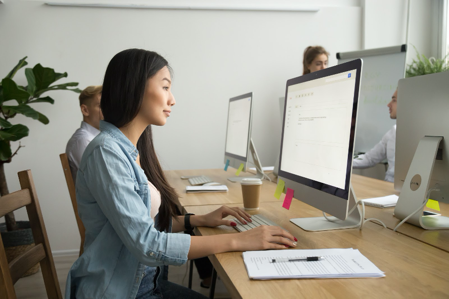 Woman seated in front of computer