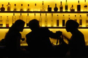 Silhouetted figures in a bar